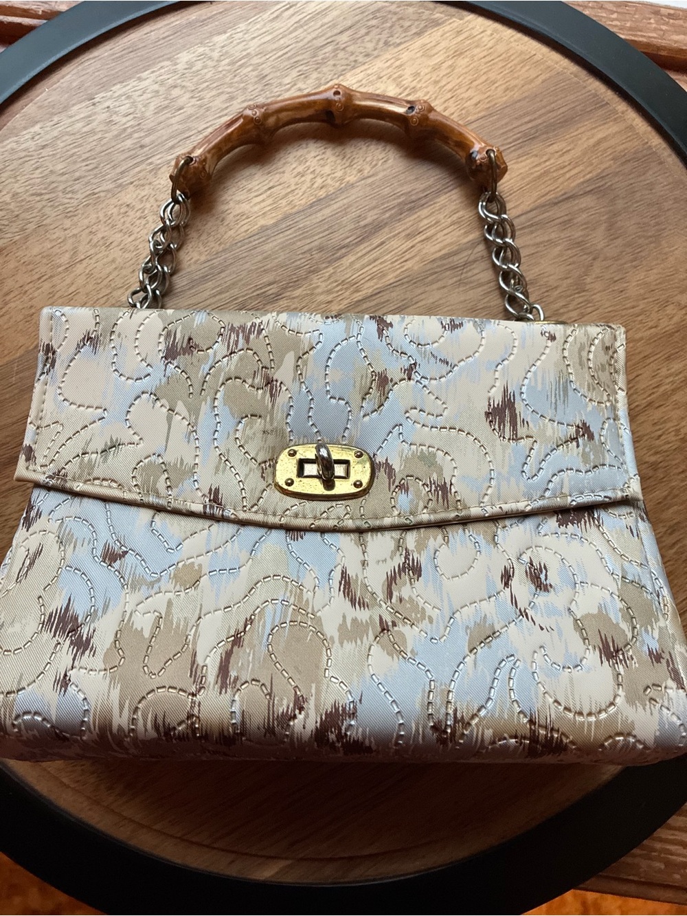 Vintage mid-century top handle handbag featuring an abstract swirled brocade
